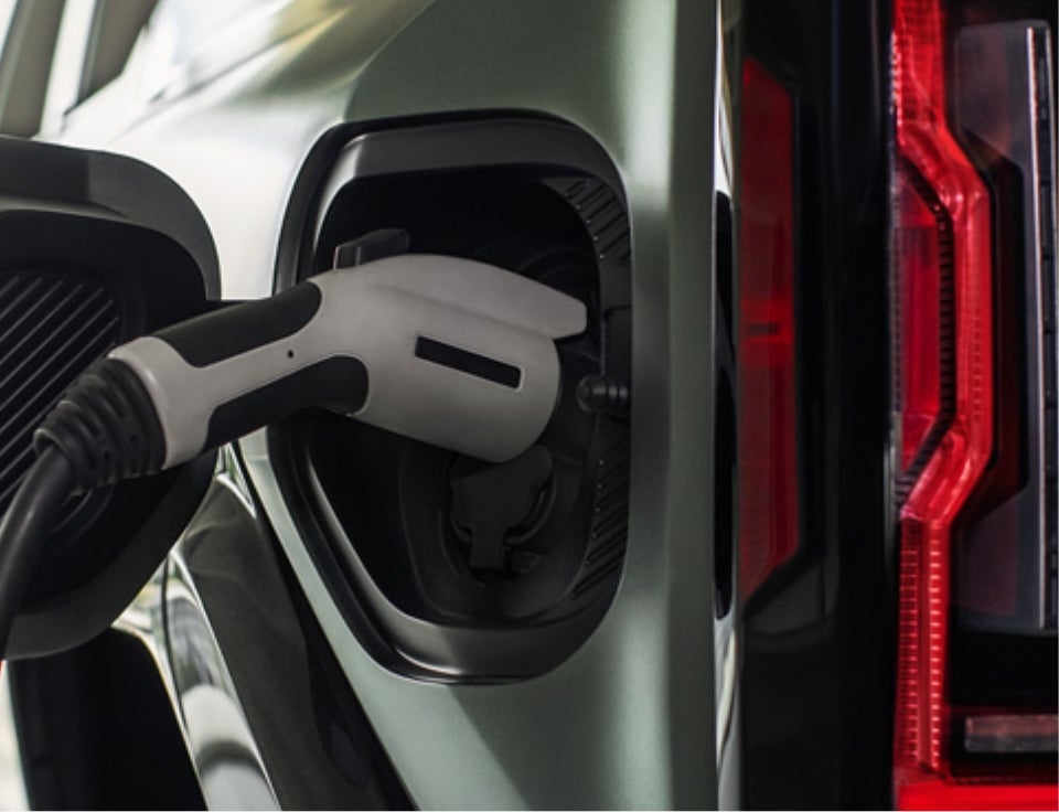 Close up of charging port with charger plugged in on a GMC Hummer EV SUV - Frank's GMC in Lyndhurst NJ